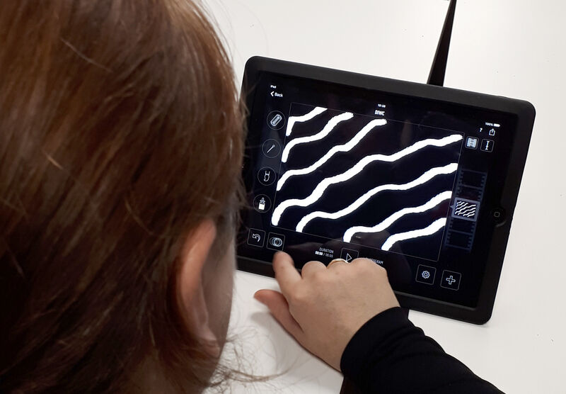 Person using an iPad to draw shapes and make an animation