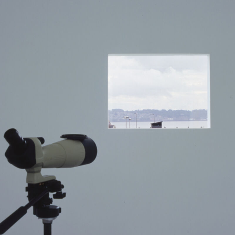 From Matts Leiderstam's exhibition in DCA Galleries. A telescope faces an image of a sea, with land and houses in the background.