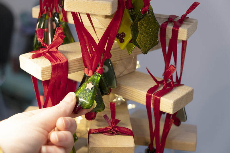 Person browsing Christmas ornaments at Crafted 2024