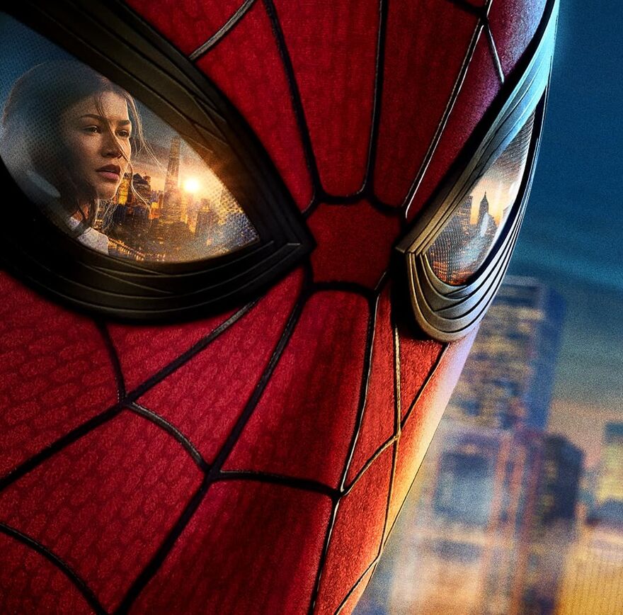 A close-up shot of Spider Man's mask with a reflection of MJ (played by Zendaya) in the left eye which is closest to us.