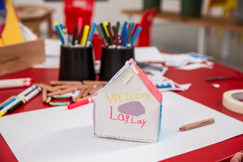 Birdhouse made from paper with text written on it saying 'Welcome LayLay'