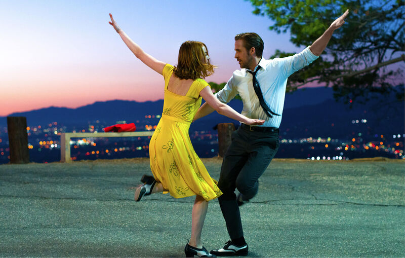 A woman and a man dance on the road in LA