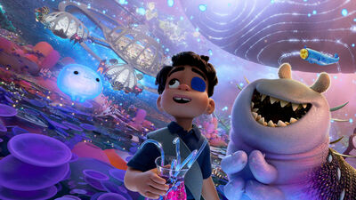 A little boy and a worm-like space alien float through a colourful galaxy together.