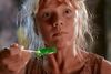 A girl looks scared as she eats green jelly