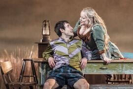 A young man flirts with a barmaid in stage play The Playboy of the Western World