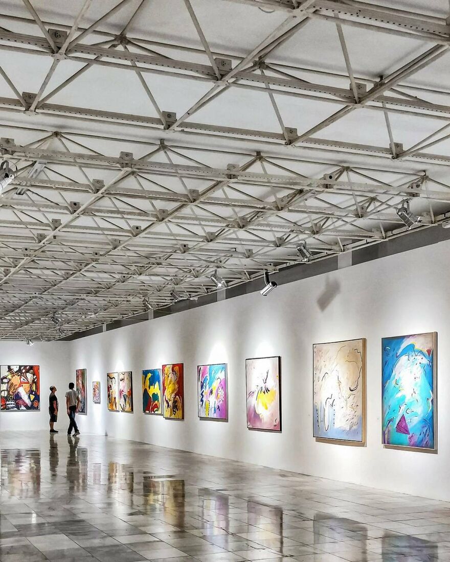 people walking around an art exhibition