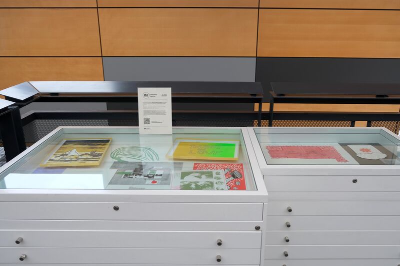 A display case with prints it in on display