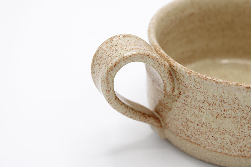 Close up on the handle of a stoneware mug