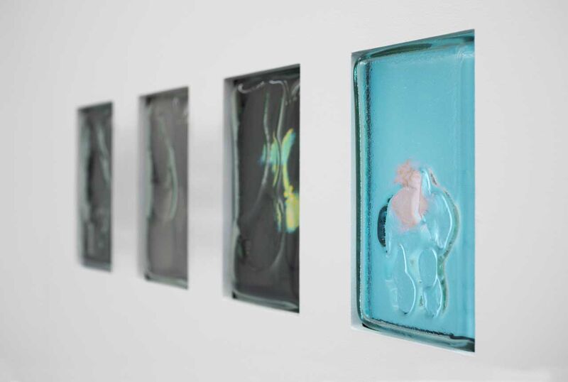 Small glass screens in a wall showing slightly out of focus objects