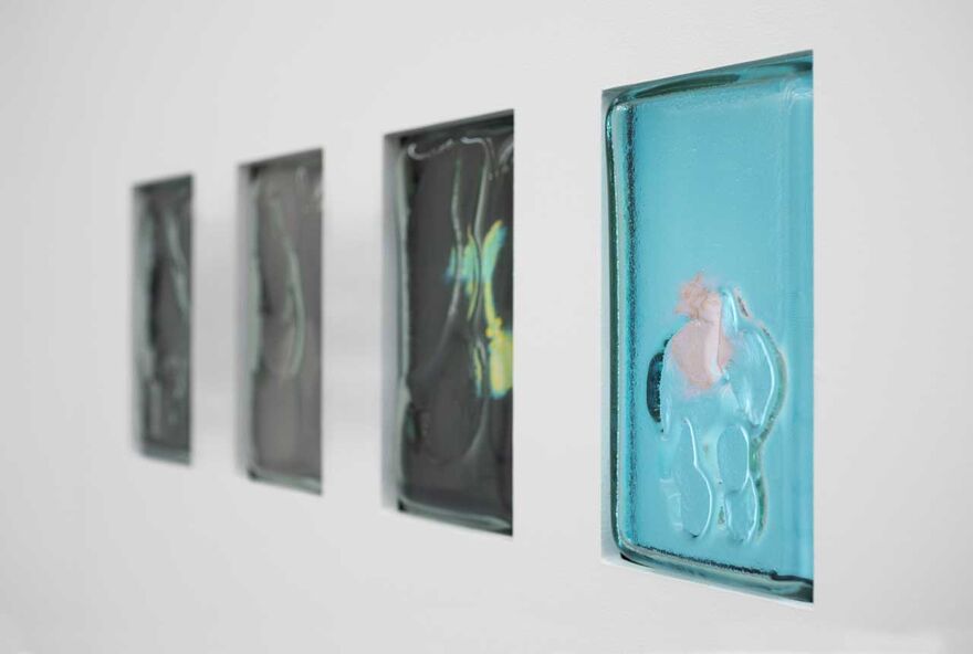 Small glass screens in a wall showing slightly out of focus objects