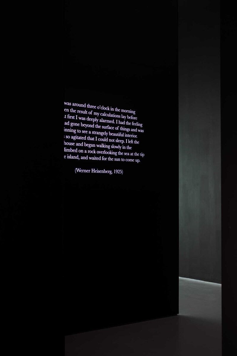 Text projected on the wall - a quote from Heisenberg