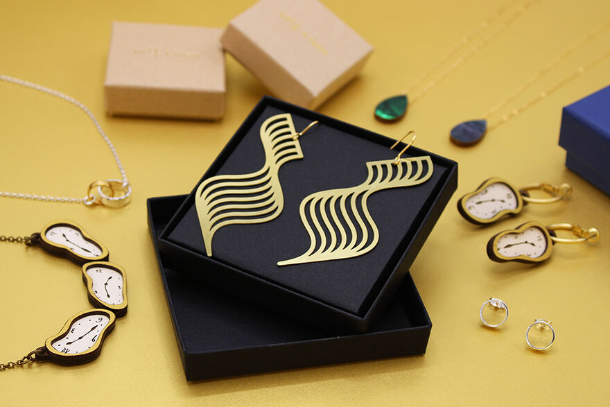 Selection of jewellery pieces and boxes against a gold background