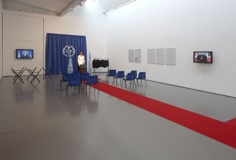 From 'Imagine Being a World Leader', DCA Galleries has been made up to look like a UN Pres Conference room, with chairs, flags and a red carpet.