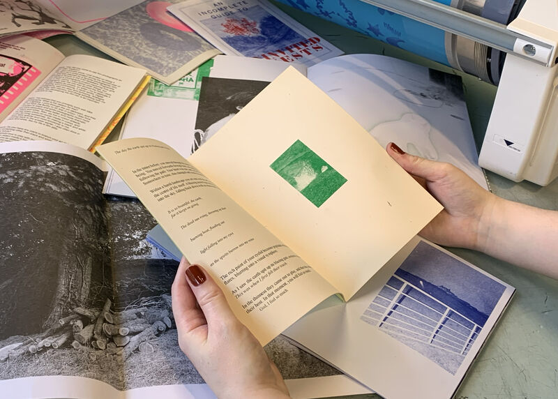 Person holding open a zine