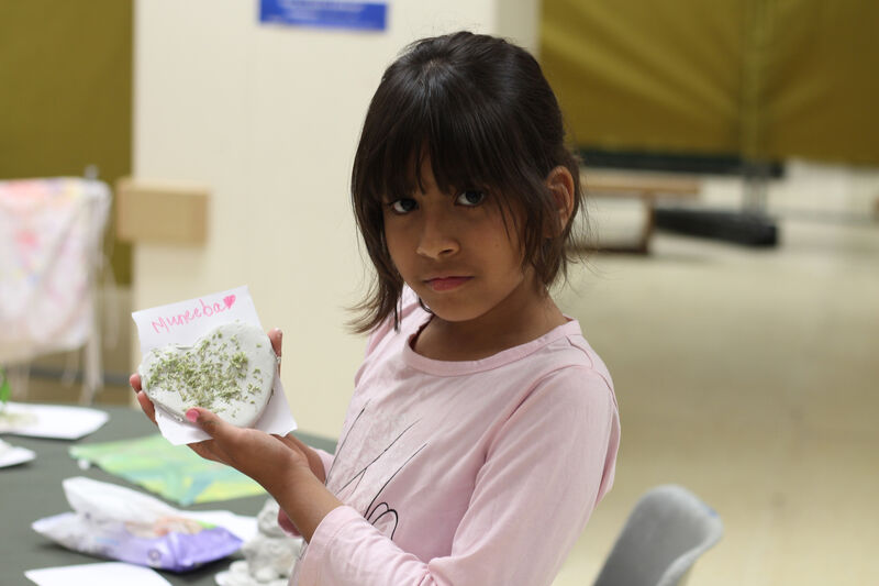 Cilding showing their clay heart creation
