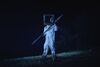Figure with box on his head and double ended spear