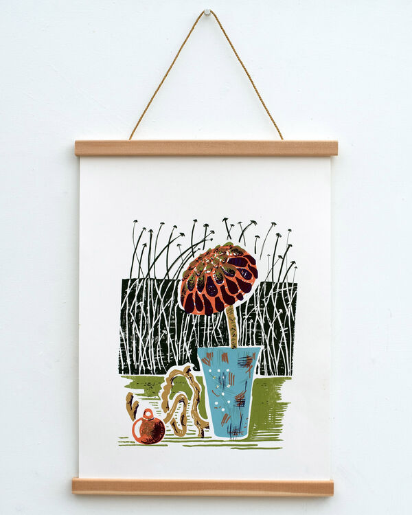 Print of a still life framed on a wall