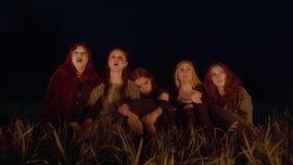 Group of 5 girls standing together outside in the dark