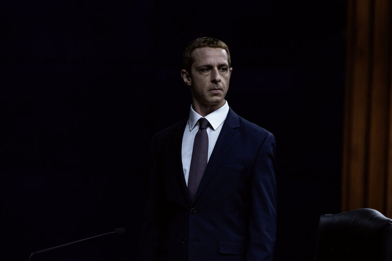 A stiff-looking man in a suit