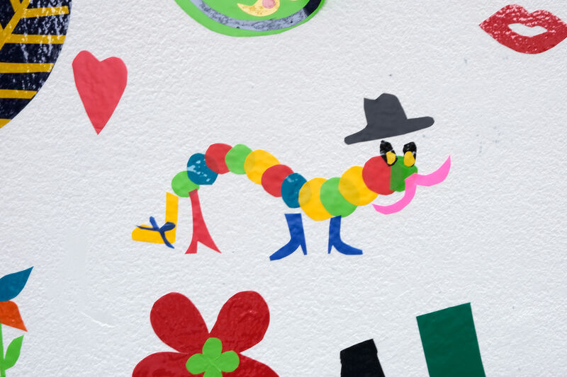 Vinyl artwork of a caterpillar wearing shoes and a hat