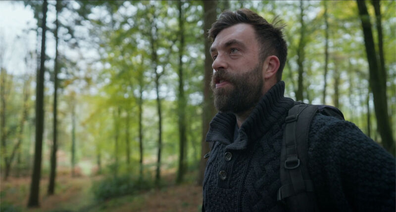 A bearded walker in the woods