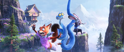 An animated rabbit, fox and snake fly through the air in a mountainous area