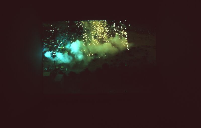 A projector shows an image of a blue, green and yellow explosion.