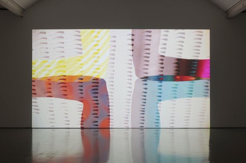 An image from Katy Dove's exhibition shows a projection screen with a colourful image of four squares. Each square's outline is a different colour.