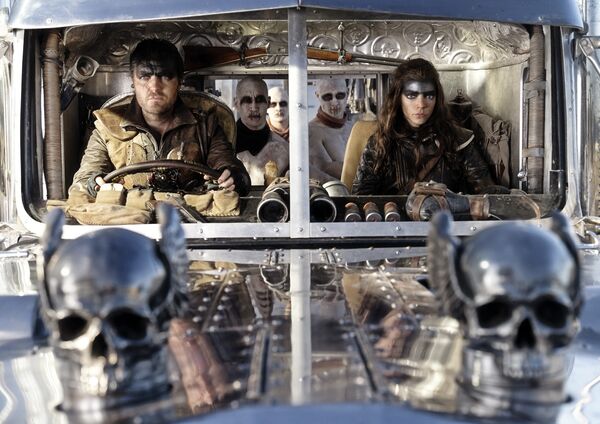 Anya Taylor Joy and Tom Burke ride in a huge silver war rig in Furiosa: A Mad Max Saga