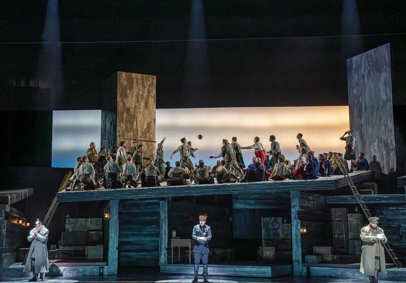 An opera with singers in military uniform playing football.