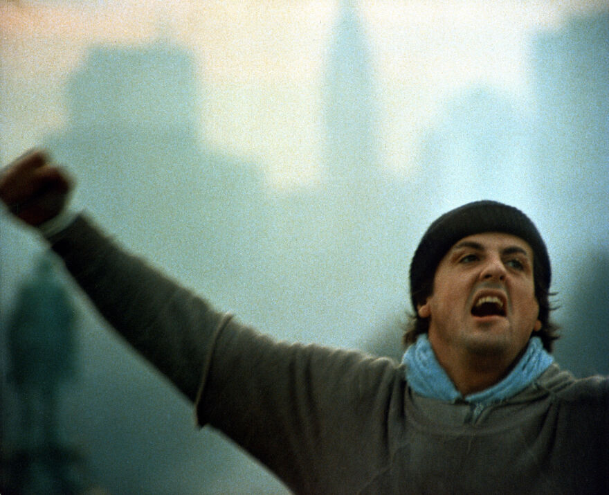 Rocky celebrates at the top of the steps