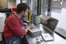 Artist drawing onto a slab of limestone