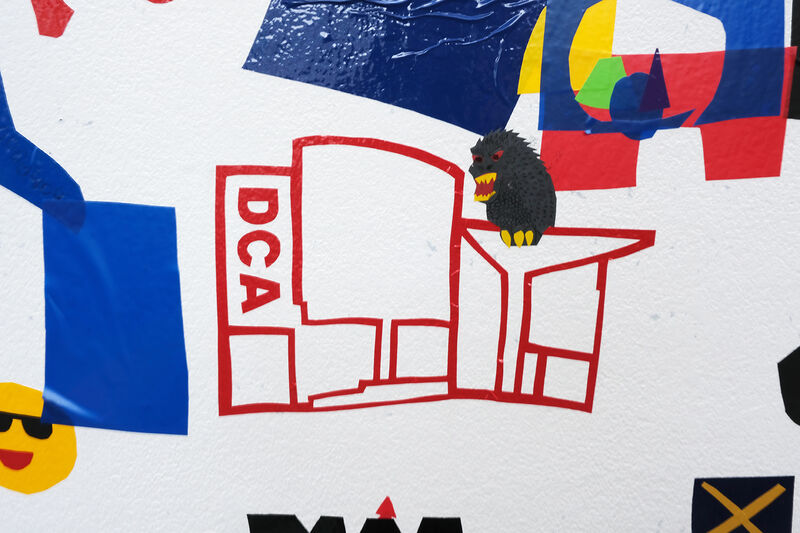Vinyl of DCA building with a monster sitting on the roof