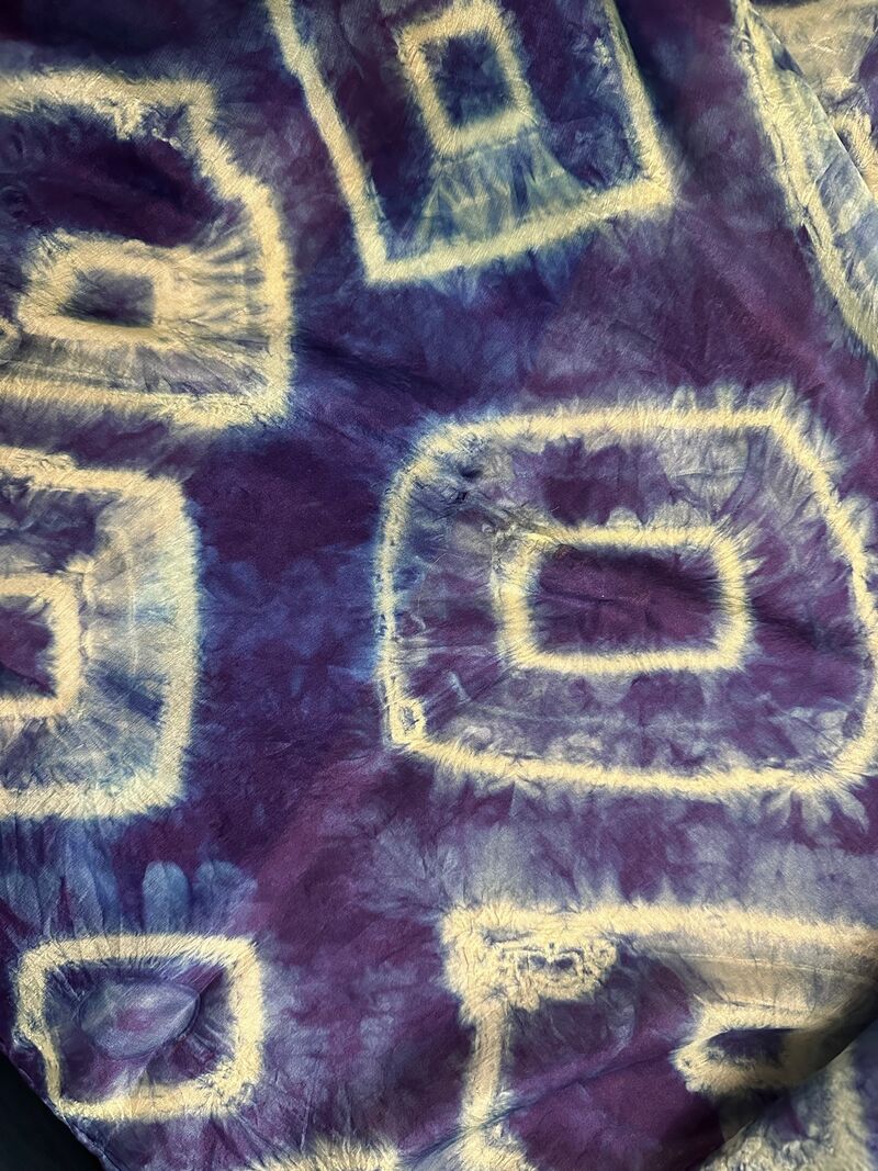 Blue silk scarf with white pattern created using the Shibori dyeing technique