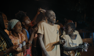A group of young people celebrate at night