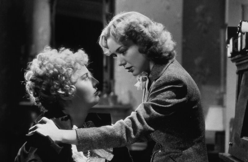 two women look at each other intensely.