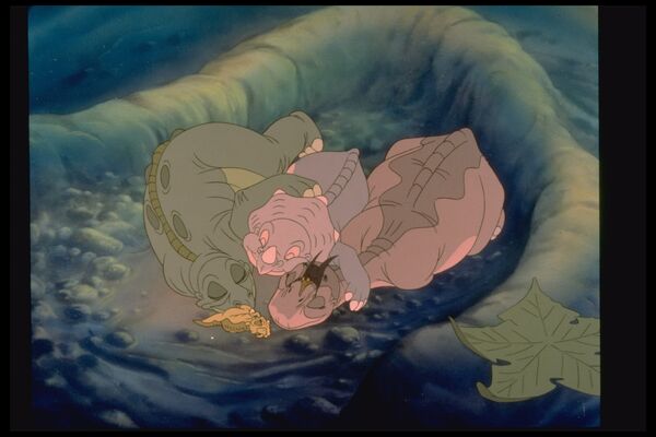 Animated dinosaurs lie in a cuddle 