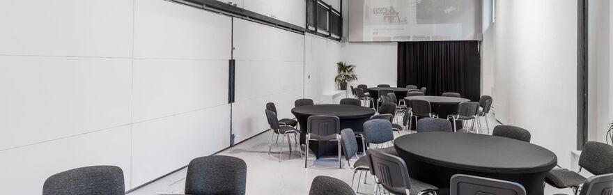 a large room with circular tables