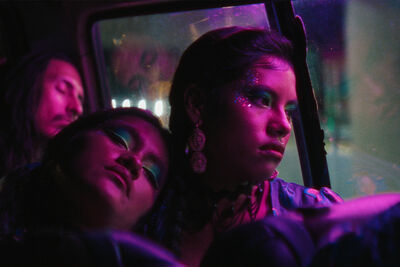Two young women on a bus late at night