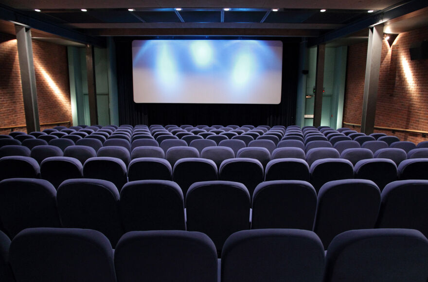 Cinema 1 at DCA with blue seats and spotlights