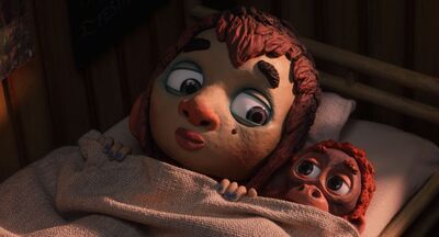 A clay animation boy shares a single bed with a small monkey.