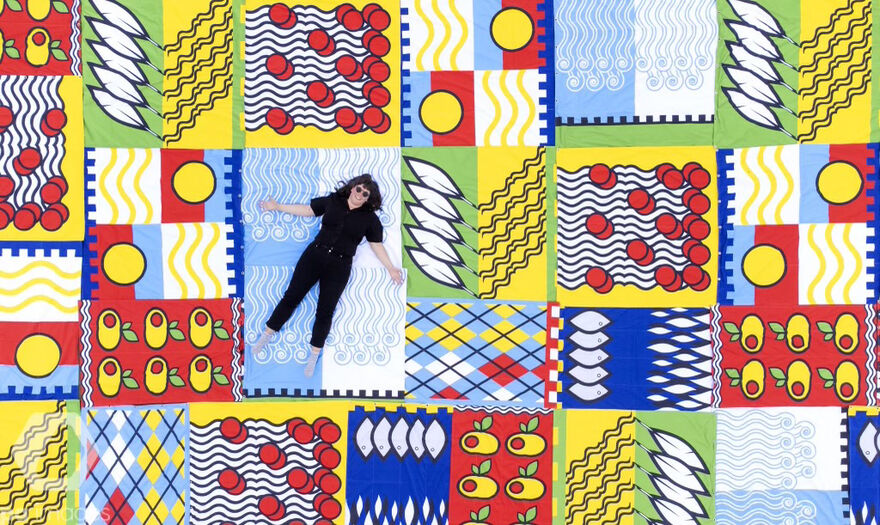 Amy Jones lying on colour flags