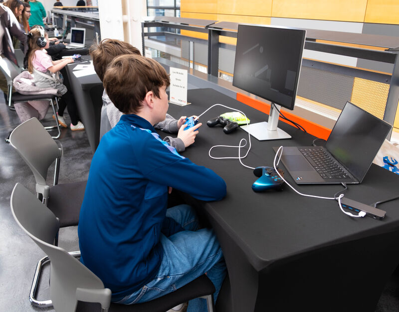 Two young boys play a game together at Drop in and Play.