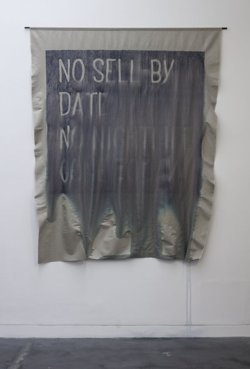 From Navid Nuur's exhibition - a piece of fabric which has been smudged by water says 'No Sell by Date'.