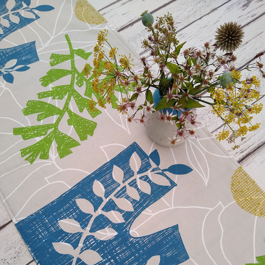 Fabric table runner printed with leaf patterns