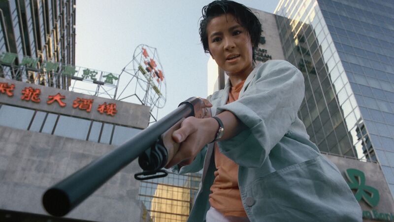 Young Michelle Yeoh holds a gun in Yes Madam