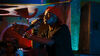 A young Black man rapping on stage