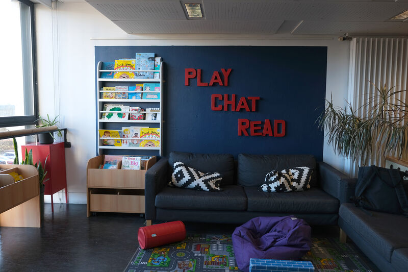 Play, chat and read section of Create Space with sofas and shelved of children's books