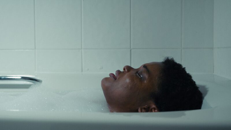 A young woman in a bubble bath.