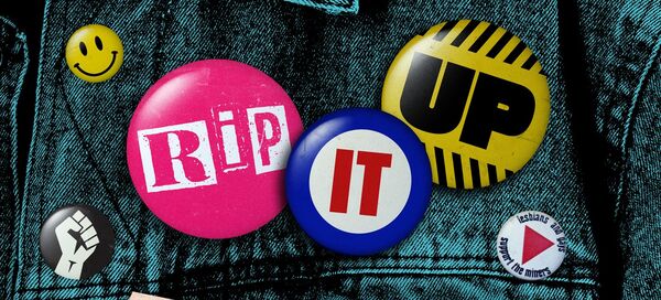 Rip It Up poster is styled as a denim jacket with pin badges.